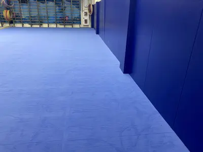 Голубой ролл-гимнаст и синие стеновые протекторы, вид вдоль стены зала