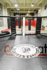 Вид изнутри октагона на зал с татами и грушами в клубе Северянин