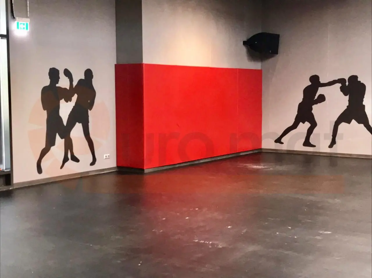 Красные стеновые протекторы на угловой колонне в зале единоборств с силуэтами боксёров на стенах в Москве