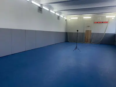 Фрагмент серых стеновых протекторов с горизонтальной прорезью в зале футбольной академии